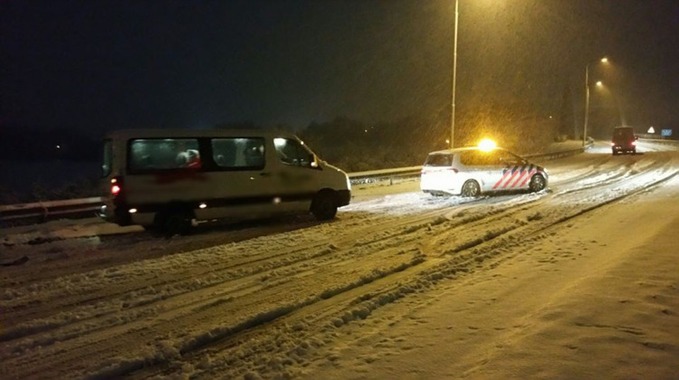 Taxibusje tegen vangrail door gladheid